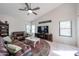 Comfortable living room featuring a ceiling fan and large flat screen television at 17806 N 54Th Ln, Glendale, AZ 85308