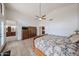 Main bedroom showcasing high ceilings, wood-look tile flooring, and access to an en-suite bathroom at 17806 N 54Th Ln, Glendale, AZ 85308