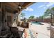 Entertainer's patio with BBQ, ceiling fan, and view of the sparkling pool at 17806 N 54Th Ln, Glendale, AZ 85308