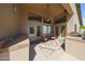 Covered patio space with seating, an outdoor kitchen, and tiled flooring at 17806 N 54Th Ln, Glendale, AZ 85308