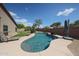 Backyard pool with surrounding patio, lounge chairs, and lush desert landscaping at 17806 N 54Th Ln, Glendale, AZ 85308