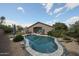Sparkling backyard pool with stone accents and views of the rear of the home at 17806 N 54Th Ln, Glendale, AZ 85308
