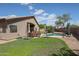 Backyard pool with patio area, lounge chairs, and shade umbrellas for outdoor enjoyment at 17806 N 54Th Ln, Glendale, AZ 85308
