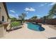 Private backyard oasis featuring a sparkling pool with lounge chairs and desert landscaping at 17806 N 54Th Ln, Glendale, AZ 85308