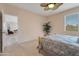 Bright bedroom with comfortable carpet, a decorative plant, and access to other rooms in the house at 17939 N Encanto Dr, Surprise, AZ 85374