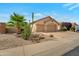 The house has desert-friendly landscaping, a three-car garage, and lovely curb appeal at 17939 N Encanto Dr, Surprise, AZ 85374