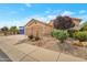 Charming home featuring a three-car garage and desert-friendly landscaping at 17939 N Encanto Dr, Surprise, AZ 85374
