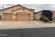 Charming single-story home featuring a two-car garage and desert landscaping at 17939 N Encanto Dr, Surprise, AZ 85374