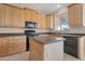 Bright kitchen with light wood cabinets, dark countertops, and modern appliances at 17939 N Encanto Dr, Surprise, AZ 85374