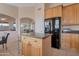 Spacious kitchen with a center island, wooden cabinets, and sleek appliances at 17939 N Encanto Dr, Surprise, AZ 85374