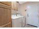 Well-equipped laundry room with cabinetry and appliances, maximizing efficiency at 17939 N Encanto Dr, Surprise, AZ 85374