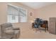 Functional office with a comfortable chair, wooden desk, filing cabinet, and bright window at 17939 N Encanto Dr, Surprise, AZ 85374