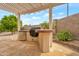 Built-in outdoor kitchen with a grill, ideal for outdoor cooking and entertaining guests at 17939 N Encanto Dr, Surprise, AZ 85374