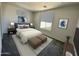 Cozy primary bedroom with a neutral color palette, window for natural light, and stylish decor at 17983 W Sand Hills Rd, Surprise, AZ 85387