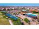 Community aerial view showcasing amenities including the pool, tennis court, and green spaces at 18009 W Sand Hills Rd, Surprise, AZ 85387
