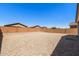 Expansive gravel backyard with brick perimeter fencing, perfect for low-maintenance outdoor living and customization at 238 W Kona Dr, Casa Grande, AZ 85122