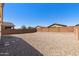 Spacious backyard area with gravel and block wall, offering a blank canvas for landscaping and outdoor activities at 238 W Kona Dr, Casa Grande, AZ 85122