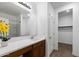 Well-lit bathroom features a spacious vanity, framed mirror, and a shower with a glass door at 238 W Kona Dr, Casa Grande, AZ 85122