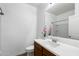 Bright bathroom with a large mirror, wood vanity, white countertop, and shower at 238 W Kona Dr, Casa Grande, AZ 85122