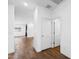 Bright hallway with wood-look floors, white walls, and views into the living area at 238 W Kona Dr, Casa Grande, AZ 85122