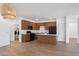 Open kitchen with black appliances, wood cabinets, and an island with a white countertop at 238 W Kona Dr, Casa Grande, AZ 85122