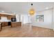Open-concept living area with a kitchen island, wood-look floors, and natural light at 238 W Kona Dr, Casa Grande, AZ 85122