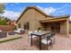 Outdoor living area with outdoor furniture, dining table, and manicured brick patio at 2629 E Beverly Rd, Phoenix, AZ 85042