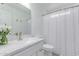 Bathroom with white vanity, shower with curtain, and brushed nickel hardware at 2629 E Beverly Rd, Phoenix, AZ 85042