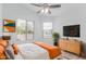 Comfortable bedroom featuring a ceiling fan, a window, and a mounted television at 2629 E Beverly Rd, Phoenix, AZ 85042