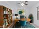 Inviting office space with a wooden desk, shelving, and a comfortable teal chair at 2629 E Beverly Rd, Phoenix, AZ 85042