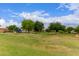 Beautiful community playground with green grass and mature trees under a sunny blue sky at 2629 E Beverly Rd, Phoenix, AZ 85042