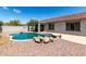 Backyard features pool, rock decorations, covered patio, and desert landscaping, perfect for entertaining at 30 S 230Th Ave, Buckeye, AZ 85326