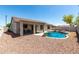 Charming backyard with sparkling pool, covered patio, and desert landscaping at 30 S 230Th Ave, Buckeye, AZ 85326