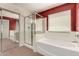 A primary bathroom featuring a soaking tub, glass shower, and tile flooring at 30 S 230Th Ave, Buckeye, AZ 85326