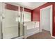 Bright bathroom featuring a shower and a soaking tub under a window at 30 S 230Th Ave, Buckeye, AZ 85326