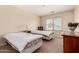 Bright bedroom featuring two beds, a window and a dresser at 30 S 230Th Ave, Buckeye, AZ 85326