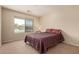 Well-lit bedroom featuring a plush bed and a large window showcasing an outside view at 30 S 230Th Ave, Buckeye, AZ 85326