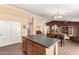 Kitchen island with dining area featuring tile floors and a decorative chandelier at 30 S 230Th Ave, Buckeye, AZ 85326