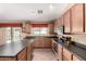 A kitchen featuring tile flooring, wood cabinets, and stainless steel appliances at 30 S 230Th Ave, Buckeye, AZ 85326