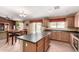 An open-concept kitchen and dining area with tile flooring and wood cabinets at 30 S 230Th Ave, Buckeye, AZ 85326