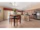Bright eat-in kitchen featuring a dining table, modern lighting, and plenty of cabinet space at 30 S 230Th Ave, Buckeye, AZ 85326