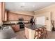 A kitchen featuring stainless steel appliances, tile flooring, and a center island with barstool seating at 30 S 230Th Ave, Buckeye, AZ 85326
