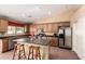 Kitchen features a breakfast bar, stainless steel appliances, and generous counter space at 30 S 230Th Ave, Buckeye, AZ 85326