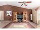 Inviting living room with a tall ceiling, a wooden media center, and stylish decor at 30 S 230Th Ave, Buckeye, AZ 85326