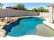 Stunning pool featuring rock waterfall, beach entry, and serene design, ideal for leisure at 30 S 230Th Ave, Buckeye, AZ 85326
