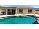 Sparkling pool with beach-style entry and lush landscaping, perfect for relaxing and entertaining outdoors at 30 S 230Th Ave, Buckeye, AZ 85326