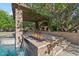 Gorgeous outdoor space with a fire feature, lush greenery, and a serene waterfall at 3011 E Morrison Ranch Pkwy, Gilbert, AZ 85296