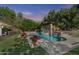Luxury backyard featuring a large pool, spa, and outdoor kitchen with a bar at 3011 E Morrison Ranch Pkwy, Gilbert, AZ 85296
