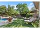 Serene backyard with lounge chairs, a pool, and lush landscaping at 3011 E Morrison Ranch Pkwy, Gilbert, AZ 85296