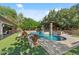Beautiful backyard featuring pool, spa, and outdoor kitchen with bar at 3011 E Morrison Ranch Pkwy, Gilbert, AZ 85296